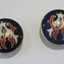 Red, white and gold monogram of AW (Alice Watson) on dark blue ground.