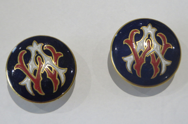 Red, white and gold monogram of AW (Alice Watson) on dark blue ground.