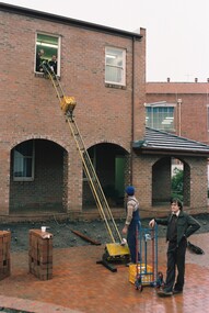 Photograph, Books being transports an a brick converyor belt to the new E.J. Tippett Library