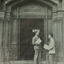 Two men on  the stairs of a doorway