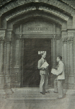 Two men on  the stairs of a doorway