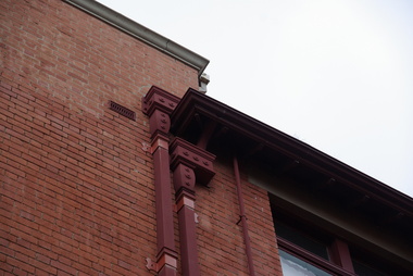 Metal downpipe on a brick building