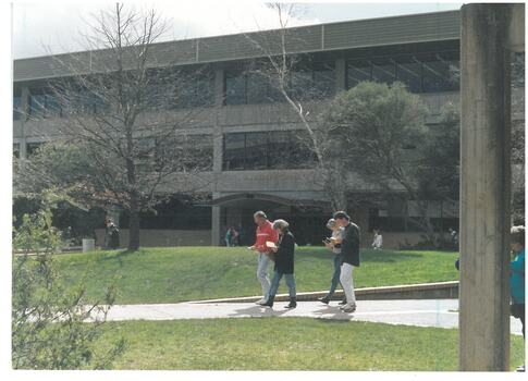 People crossing the courtyard outside the E.J. Barker Library