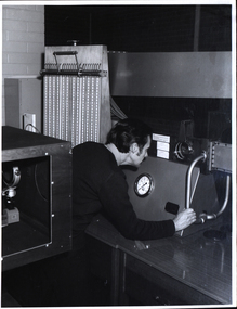 A man checks readings of a wind tunnel
