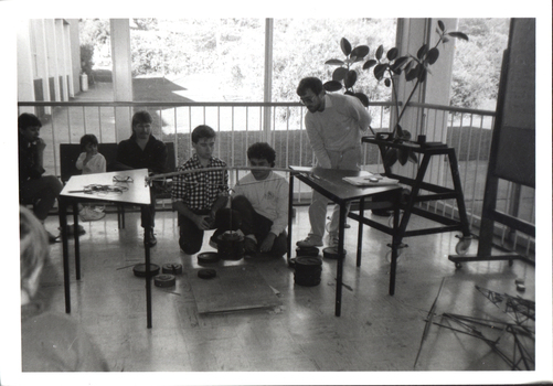 Six people watch a demostration