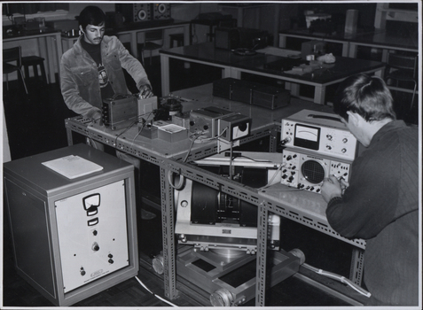 Two students working on electrical equipment