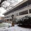 Snow in a courtyard featuring the E.J. Barker Library