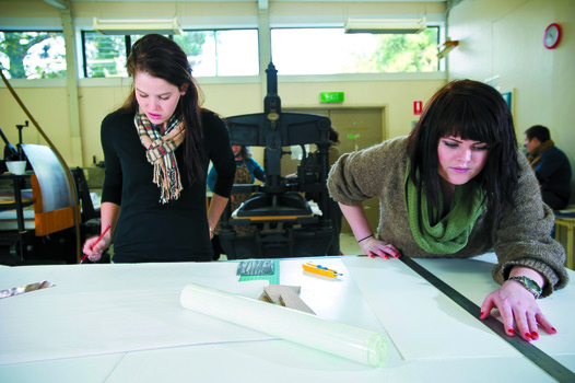 Two students in a printmaking studio