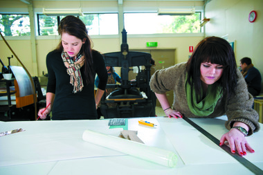 Two students in a printmaking studio