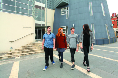 Four students walking at the Arts Academy