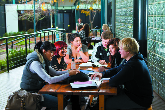 Students sit around a table