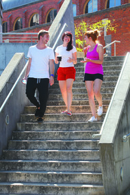 Three university students walking down steps