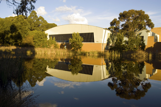 A swimming pool building behind a dam