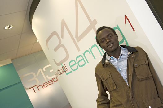 A man leans against a wall