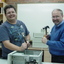Two men work on a computer
