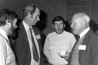 Photograph, Four men in conversation, 1982