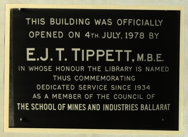 Metal plaque commemorating the opening of the E.J. Tippett Library