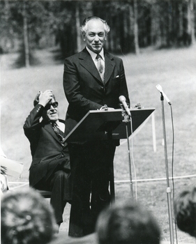 A man stands at a microphone.