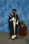 A mace bearer wearing academuic regalia