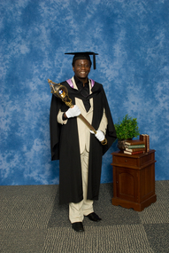 A mace bearer wearing academuic regalia