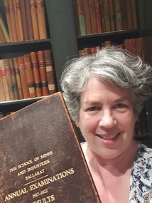 portrait of a woman holding a book