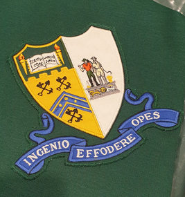 Table cloth with embroidered patch of the Ballarat School of Mines Logo. 