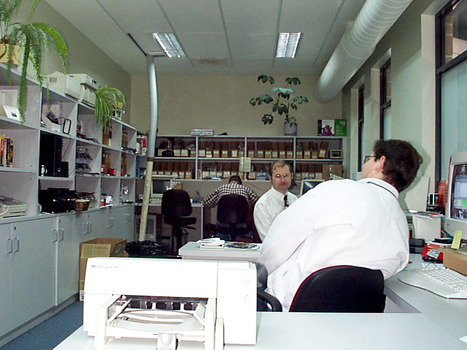 Three men in a computer room