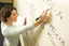 Student writing on whiteboard