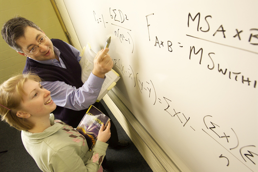 Lecturer instructing student