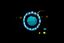 A central blue circle is ringed by small photographs of students. Touching student with cursor activates their name. Other circles float on a black background.