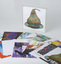 Hard plastic transparent hinged case holds 17 printed cards featuring student work.