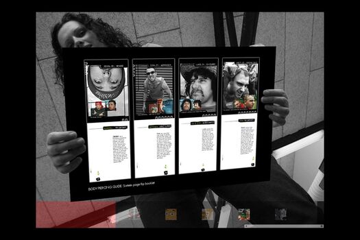 Black and white photograph of student, viewed from below holding a coloured presentation card of their work: series of page spreads for Body Piercing Guide
