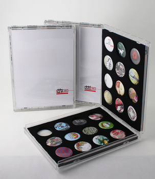 Three cases of a limited edition run of 240 packs, each containing 24 badges. Case #104 of 240 is open to display badges.