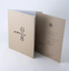 Multi-page full colour book, uncoated brown perfect bound cover, single colour (black) deboss, plus matching invitation card.