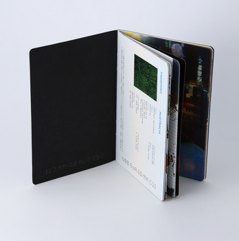Inside cover black card demonstrating laser-cut alpha-numerals, and full colour printed initial page.