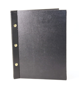 Black textured binder of plastic sleeves, bound by three brass screws. 