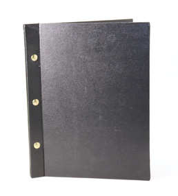 Black textured binder of plastic sleeves, bound by three brass screws. 