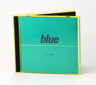 Blue paper sleeve housed in yellow plastic case (so printed item appears teal coloured). Large wording, lower case "blue".