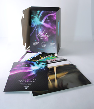 Opened, black cardboard folder package, revealing suite of A5 printed cards.