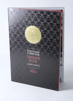 Black cover with gloss varnish pattern, gold foil serrated circle with lettering ADGD, other lettering below in white and red.