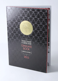 Black cover with gloss varnish pattern, gold foil serrated circle with lettering ADGD, other lettering below in white and red.