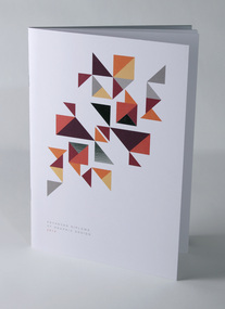 Cover, white booklet, Geometric design of floating triangles in shades of yellows, oranges, greys and reflective silver foil.