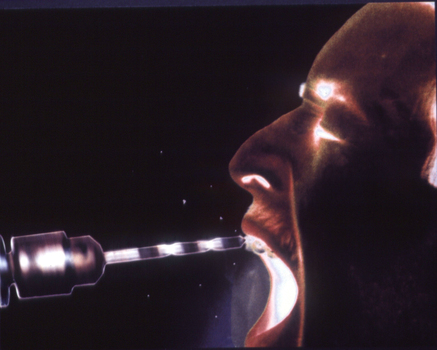 Scan of photographic horizontal image, inverted colour, teeth being drilled with construction drill