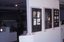 Scan of 35mm slide of exhibition space featuring frames of student work, and plinths displaying student packaging