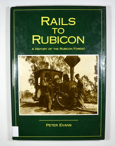 Hardcover. Green dust cover. Front cover photograph is Krauss 0-4-OWT, builder's No. 2459 of 1891, takes water at the western end of Rubicon Lane in 1934. Driver Bob Rees attends to his engine while brakeman Hayden looks on. End papers show a photograph of a man standing besides a timber railway trolley holding onto the brake lever. There is a group of men, some sitting and some standing, on piles of cut timber under a large, open shed in the background.There are also some small, timber, tent like structures standing next to the railway tracks. There is a forest in the far background. Written in white is the line "Mr Clarke & Kidd's Sawmill". 
