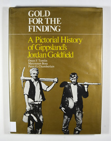 Hardcover. Gold dust cover. Front cover has a photograph of two miners carrying mining equipment.