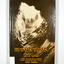Hardback. Brown dust cover. Photograph on front cover looks out from the entry of a mine onto the front of a building which has a hill to the side of it. The back cover has a photograph of the side of a hill with some trees on it.