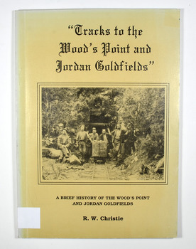 Paperback. Beige cover. Front cover has a black and white photograph of miners standing and sitting around a mine cart that is sitting on railway tracks at the entrance to a mine.Back cover has a cartoon drawing of a pack horse that has fallen down a cliff with his rider trying to pull him back up by his tail. Inside the cover is a drawn map entitled 'Map of the Mining District round Wood's point'.