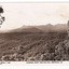 Shows a view of the range of mountains known as the Cathedral Range including Mount Cathedral. In the foreground are a series of heavily forested hills. On the reverse of the postcard is space to write a message and an address and to place a postage stamp. The postcard is unused.