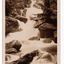 Shows Keppel Falls which is accesible from Lady Talbot Drive. Shows the falls cascading over large rocks through the forest. On the reverse of the postcard a handwritten message.